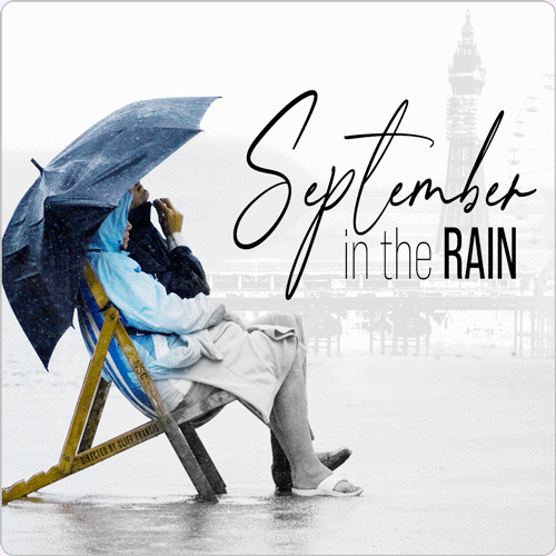 September in the Rain by John Godber production poste image. A couple sat on a wet, rainy Blackpool beach
